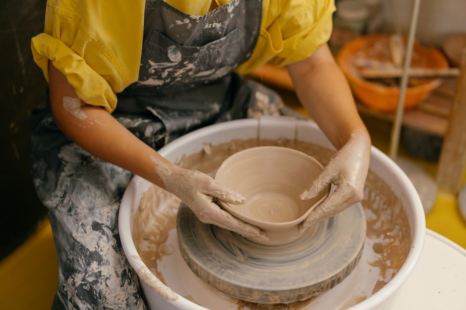 hands mending ceramic bowl